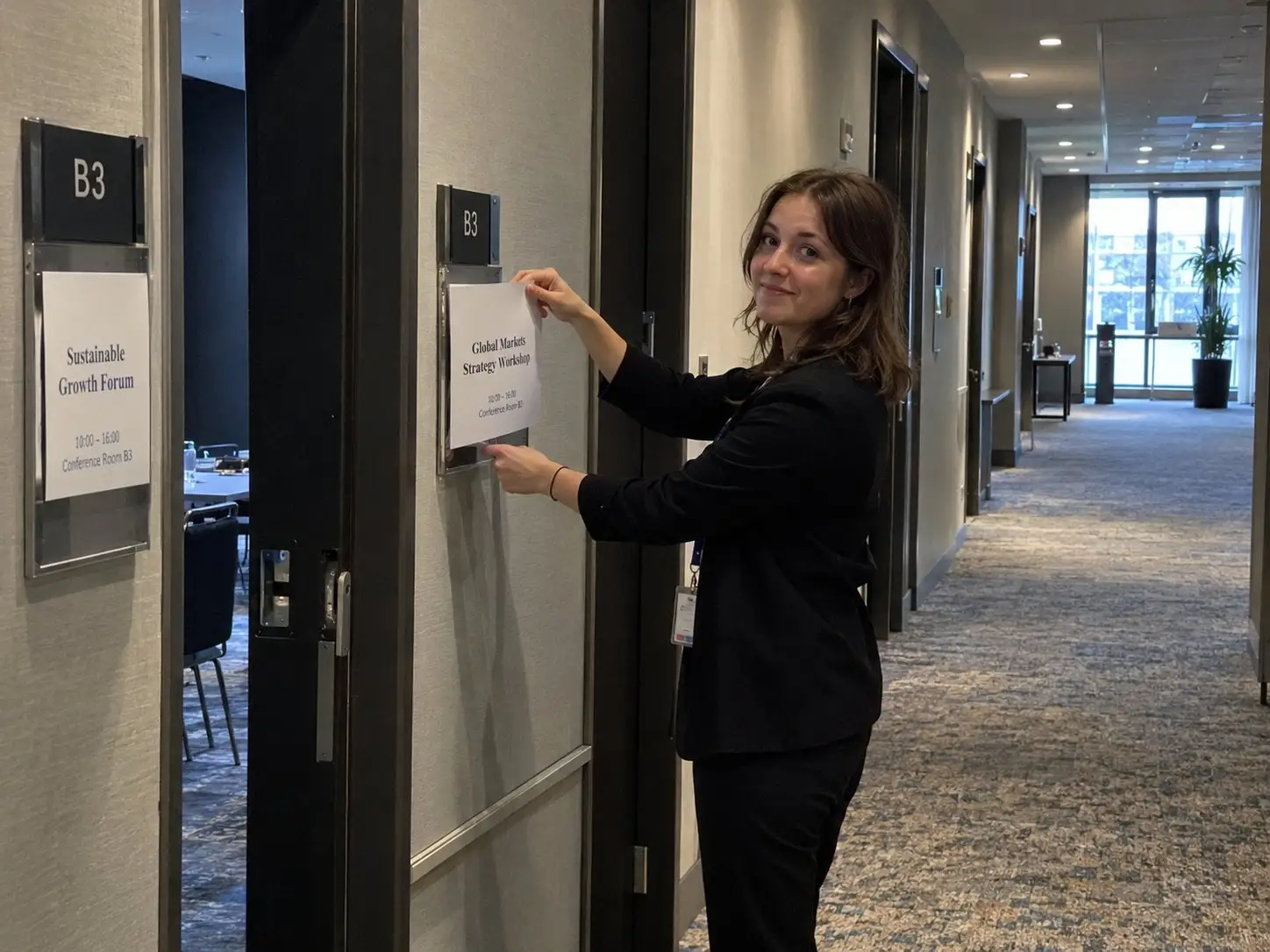 Conference hostess puts up room signs in a conference hotel