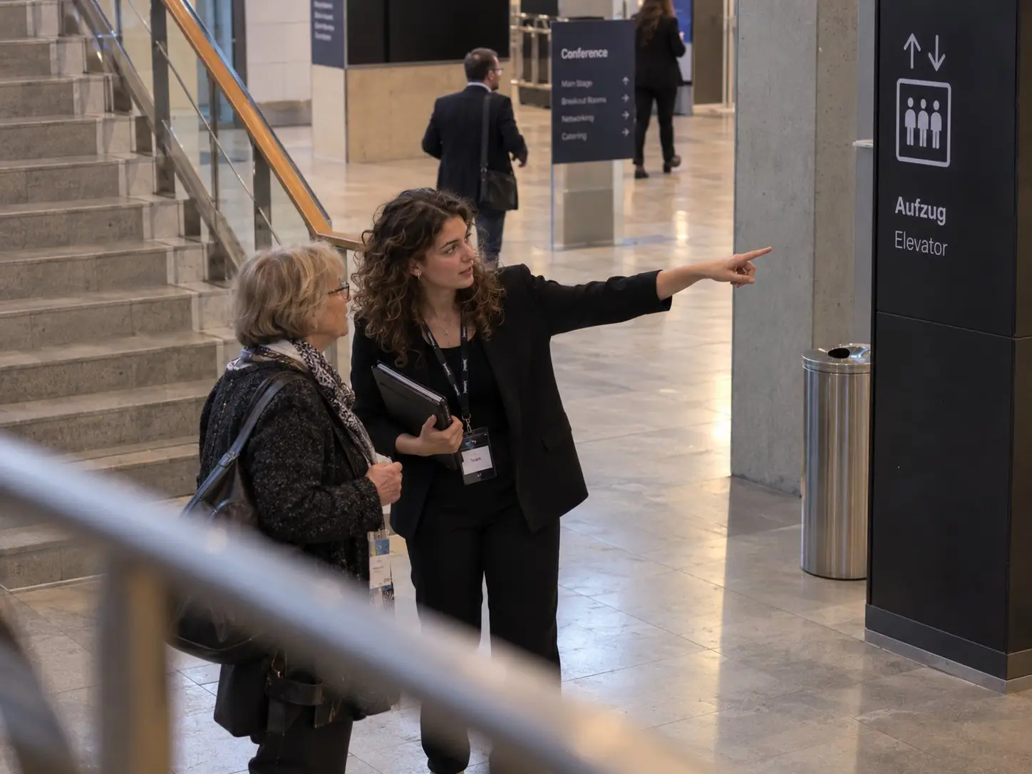Host shows a conference guest the way to the lift