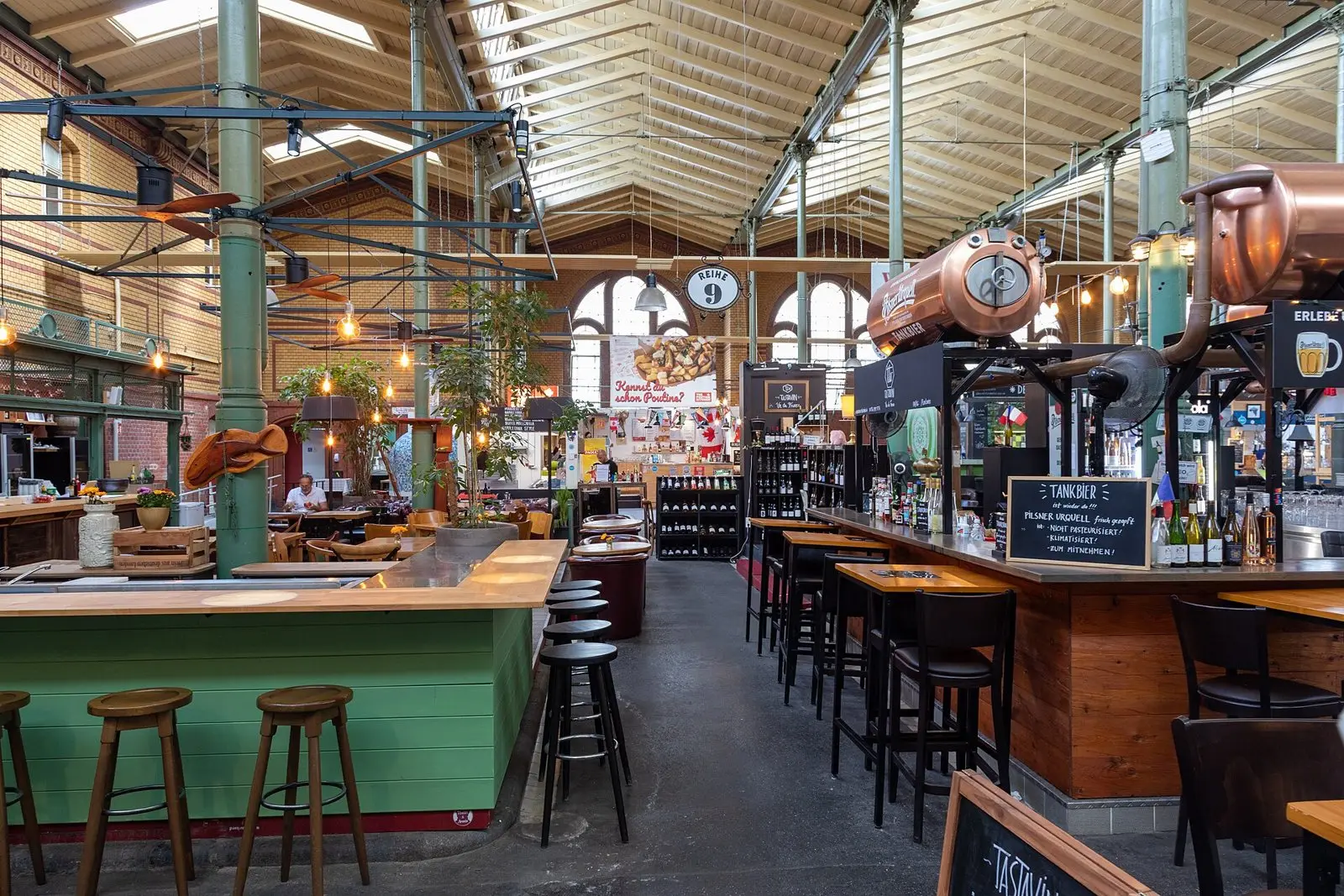 Inside the Arminiusmarkthalle market hall in Moabit with counters and bar stools