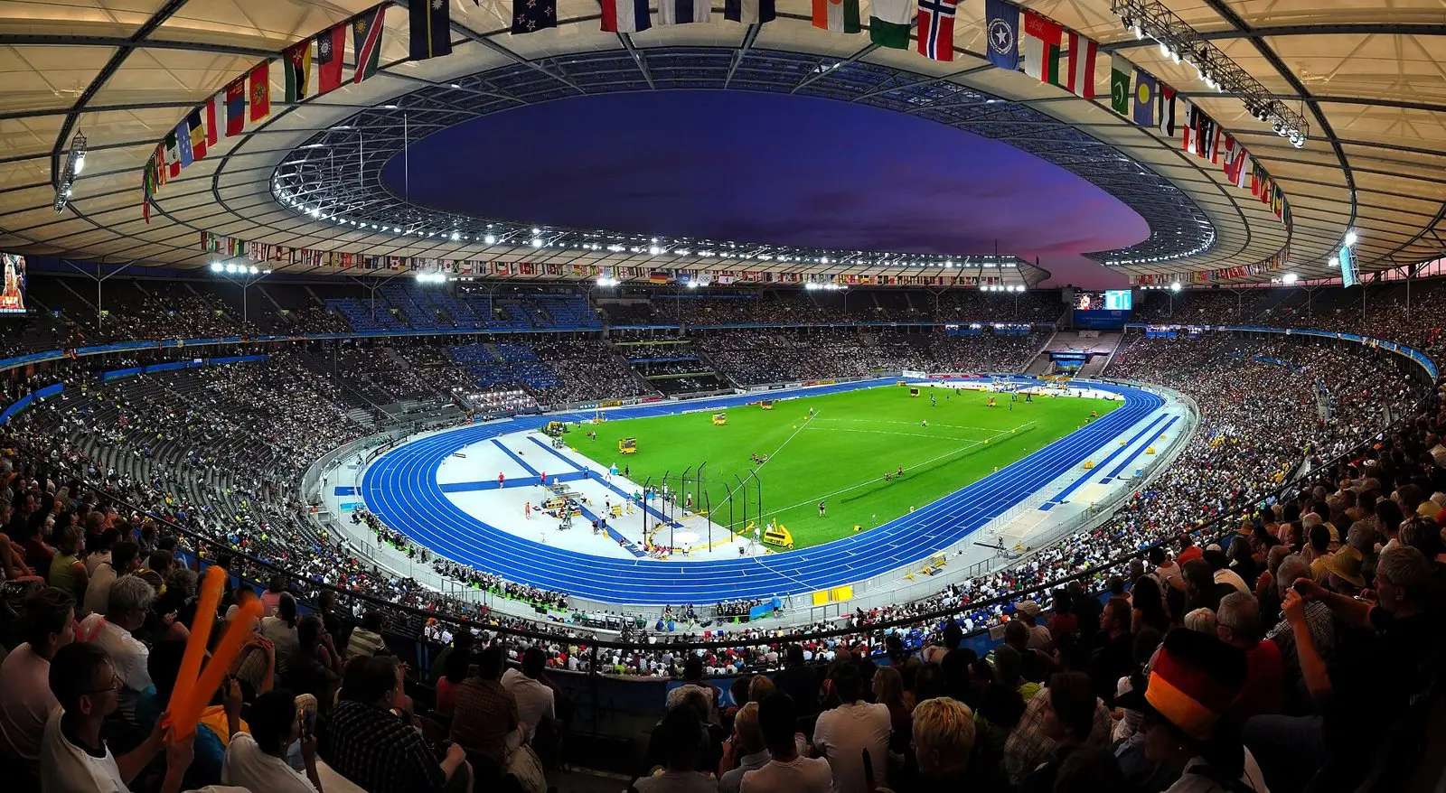 The packed Olympiastadion Berlin under floodlights